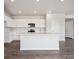 Well-appointed kitchen with an island, stainless steel appliances, white cabinets, and stone counter tops at 2177 Flower Blossom Ave, Brighton, CO 80601