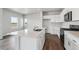 Well-lit kitchen featuring modern appliances, ample counter space, and an island, creating an efficient workspace at 2177 Flower Blossom Ave, Brighton, CO 80601