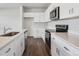 Modern kitchen featuring stainless steel appliances, white cabinetry, and stone counter tops at 2177 Flower Blossom Ave, Brighton, CO 80601