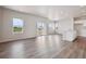 Bright and airy living room features wood floors, recessed lighting and sliding glass doors to backyard at 2177 Flower Blossom Ave, Brighton, CO 80601