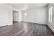 Spacious room with wood floors, white walls, natural light, and two white doors at 2177 Flower Blossom Ave, Brighton, CO 80601