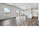 Open-concept living room boasts natural light and hard wood floors, creating an airy and welcoming space at 2177 Flower Blossom Ave, Brighton, CO 80601
