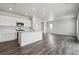 Bright, open-concept living area featuring modern finishes, an abundance of natural light, and stylish flooring at 2177 Flower Blossom Ave, Brighton, CO 80601