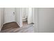 Powder room with a commode, sink, and wood floor at 2177 Flower Blossom Ave, Brighton, CO 80601