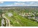 Panoramic view shows a community near a golf course with a lake, greenways, and neighborhood streets at 9441 Southern Hills Cir, Lone Tree, CO 80124