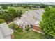 Aerial view showcases the property nestled in a community beside a golf course and mature trees at 9441 Southern Hills Cir, Lone Tree, CO 80124