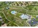 Aerial view features a community pool, tennis courts, walking trails, and nearby residential properties at 9441 Southern Hills Cir, Lone Tree, CO 80124