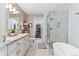 Spa-like bathroom with a soaking tub, glass-enclosed shower, and granite countertops at 9441 Southern Hills Cir, Lone Tree, CO 80124