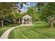 Charming gazebo with benches surrounded by meticulously manicured landscaping on a sunny day at 9441 Southern Hills Cir, Lone Tree, CO 80124