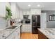 Bright kitchen featuring granite countertops, stainless steel appliances, and white cabinetry at 9441 Southern Hills Cir, Lone Tree, CO 80124