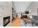 Open living space with a stone fireplace and seamless flow to other rooms at 9441 Southern Hills Cir, Lone Tree, CO 80124