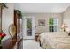 Comfortable main bedroom with natural light, balcony access, and stylish furnishings at 9441 Southern Hills Cir, Lone Tree, CO 80124