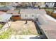 Aerial view showcasing backyard featuring garage, fire pit, patio, and landscaping at 3021 Grape St, Denver, CO 80207