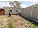 Backyard featuring a rustic fire pit, garden, and wooden shed at 3021 Grape St, Denver, CO 80207