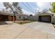 Backyard view of the driveway with a basketball hoop, garage, and storage sheds at 3021 Grape St, Denver, CO 80207