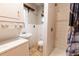 Bathroom featuring a shower, toilet, sink and stackable washer dryer at 3021 Grape St, Denver, CO 80207