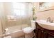 Bathroom featuring a sink, toilet and shower tub combo at 3021 Grape St, Denver, CO 80207