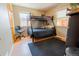 Cozy bedroom with a bunk bed, a wooden chair, and laminate floors at 3021 Grape St, Denver, CO 80207
