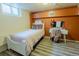 Bright bedroom featuring a vanity, and wood-look laminate flooring at 3021 Grape St, Denver, CO 80207