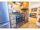 Kitchen featuring stainless steel stove, refrigerator and diamond tile backsplash at 3021 Grape St, Denver, CO 80207