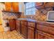 Rustic kitchen featuring wood cabinets, stainless steel sink and diamond tile backsplash at 3021 Grape St, Denver, CO 80207