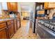 Kitchen with stainless steel appliances, wood cabinets, and tile flooring at 3021 Grape St, Denver, CO 80207