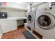 Laundry room featuring built in shelves and washer and dryer at 3021 Grape St, Denver, CO 80207