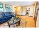 Inviting living area with dark sofas and a glimpse into the kitchen at 3021 Grape St, Denver, CO 80207