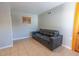 Cozy living room with a black couch and neutral walls, complemented by tile flooring at 3021 Grape St, Denver, CO 80207