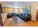 Cozy living room with dark leather sofas, wood floors, and neutral-colored walls at 3021 Grape St, Denver, CO 80207