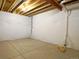 Unfinished basement with exposed ceiling and concrete floor ready for your personalization at 11860 Sandcastle Ct, Parker, CO 80138