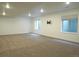 Spacious finished basement with neutral carpet, recessed lighting, and two egress windows at 11860 Sandcastle Ct, Parker, CO 80138