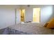 Bright bedroom with a queen bed featuring a floral pattern, white walls, and carpeted floors at 11860 Sandcastle Ct, Parker, CO 80138