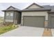 A well-maintained home featuring a two-car garage, attractive stone accents, and a concrete driveway at 11860 Sandcastle Ct, Parker, CO 80138