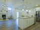 Bright open floor plan with white kitchen cabinets, stainless appliances, and hardwood floors at 11860 Sandcastle Ct, Parker, CO 80138