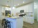 Modern kitchen featuring white cabinets, granite countertops, and hardwood floors at 11860 Sandcastle Ct, Parker, CO 80138