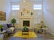 Living room featuring a fireplace, neutral decor, and gray hardwood floors at 11860 Sandcastle Ct, Parker, CO 80138