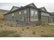 View of the home's side exterior, fenced yard, and low maintenance landscaping at 11860 Sandcastle Ct, Parker, CO 80138