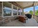 Covered porch with stone accents and wooden table and chairs, perfect for outdoor dining at 5663 W 96Th Ave, Westminster, CO 80020