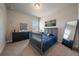 Comfortable bedroom featuring a twin bed, dresser, large mirror, and unique Denver wall art at 5663 W 96Th Ave, Westminster, CO 80020