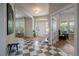 Bright foyer features checkered tile, white door, and view of an inviting sitting room at 5663 W 96Th Ave, Westminster, CO 80020
