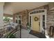 Inviting covered front porch with stone accents, seating area, and stylish decor at 5663 W 96Th Ave, Westminster, CO 80020