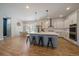 Modern kitchen featuring a large island with seating and stainless steel appliances at 5663 W 96Th Ave, Westminster, CO 80020