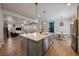 Open kitchen featuring island with seating, modern fixtures, and seamless living area access at 5663 W 96Th Ave, Westminster, CO 80020