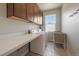Functional laundry room with countertop and cabinets for storage at 5663 W 96Th Ave, Westminster, CO 80020
