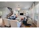 Bright living room featuring elegant chandelier, plush seating, and staircase at 5663 W 96Th Ave, Westminster, CO 80020
