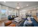 Spacious living room with many windows, leading into a modern kitchen area at 5663 W 96Th Ave, Westminster, CO 80020