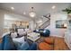 Open-concept living room showcasing hardwood floors, natural light, and comfortable seating at 5663 W 96Th Ave, Westminster, CO 80020