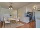 Dining space featuring hardwood floors, white cabinetry, marble table and stairs at 1013 Homestake Dr # 17C, Golden, CO 80401