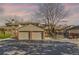 Exterior view of multi-unit townhomes, featuring attached garages and mature trees, providing a comfortable community setting at 1013 Homestake Dr # 17C, Golden, CO 80401